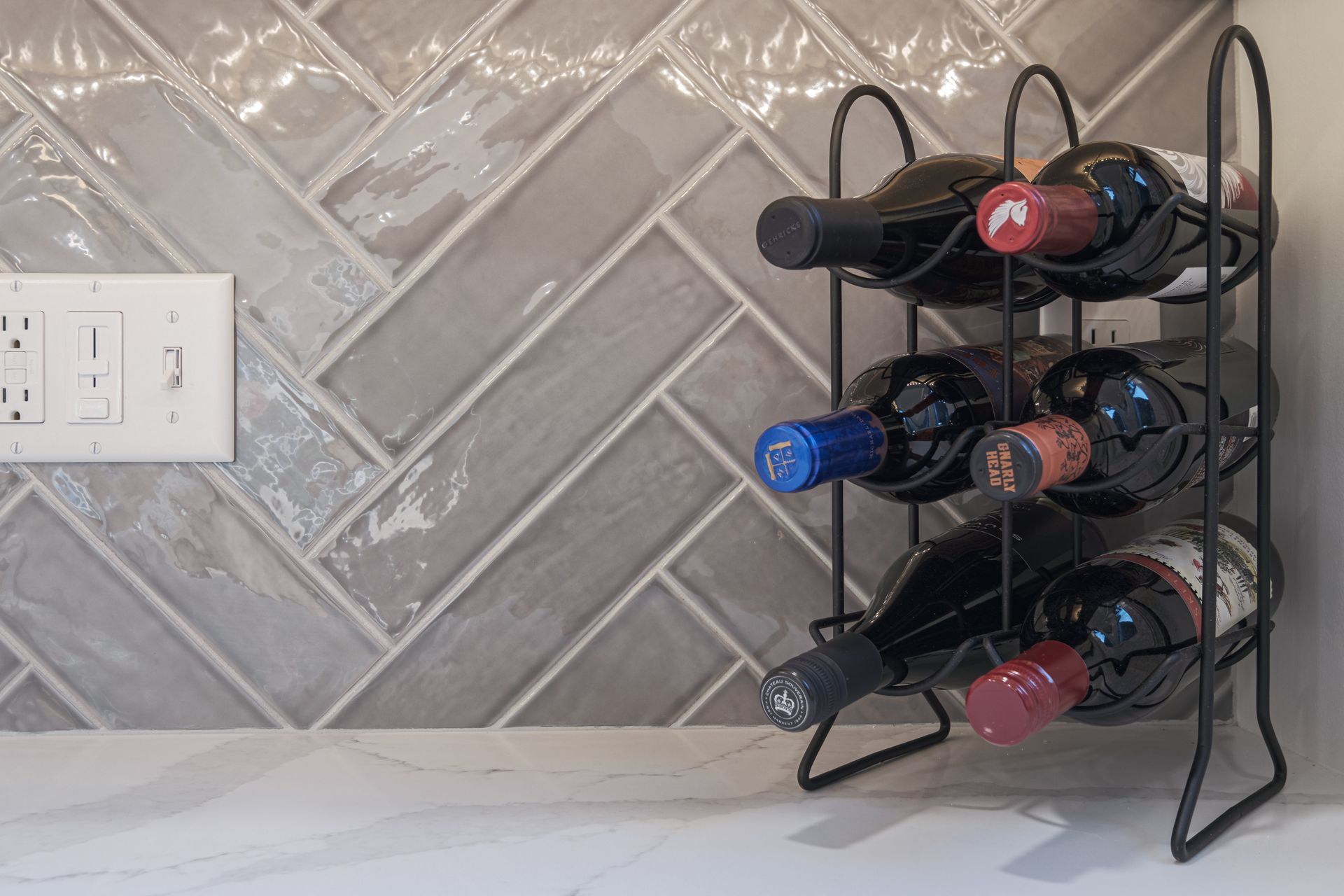 A wine rack filled with wine bottles on a counter.