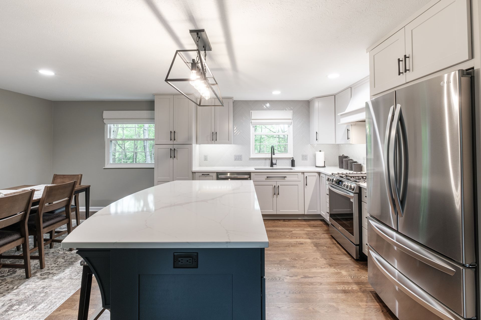 A kitchen with stainless steel appliances and a large island.