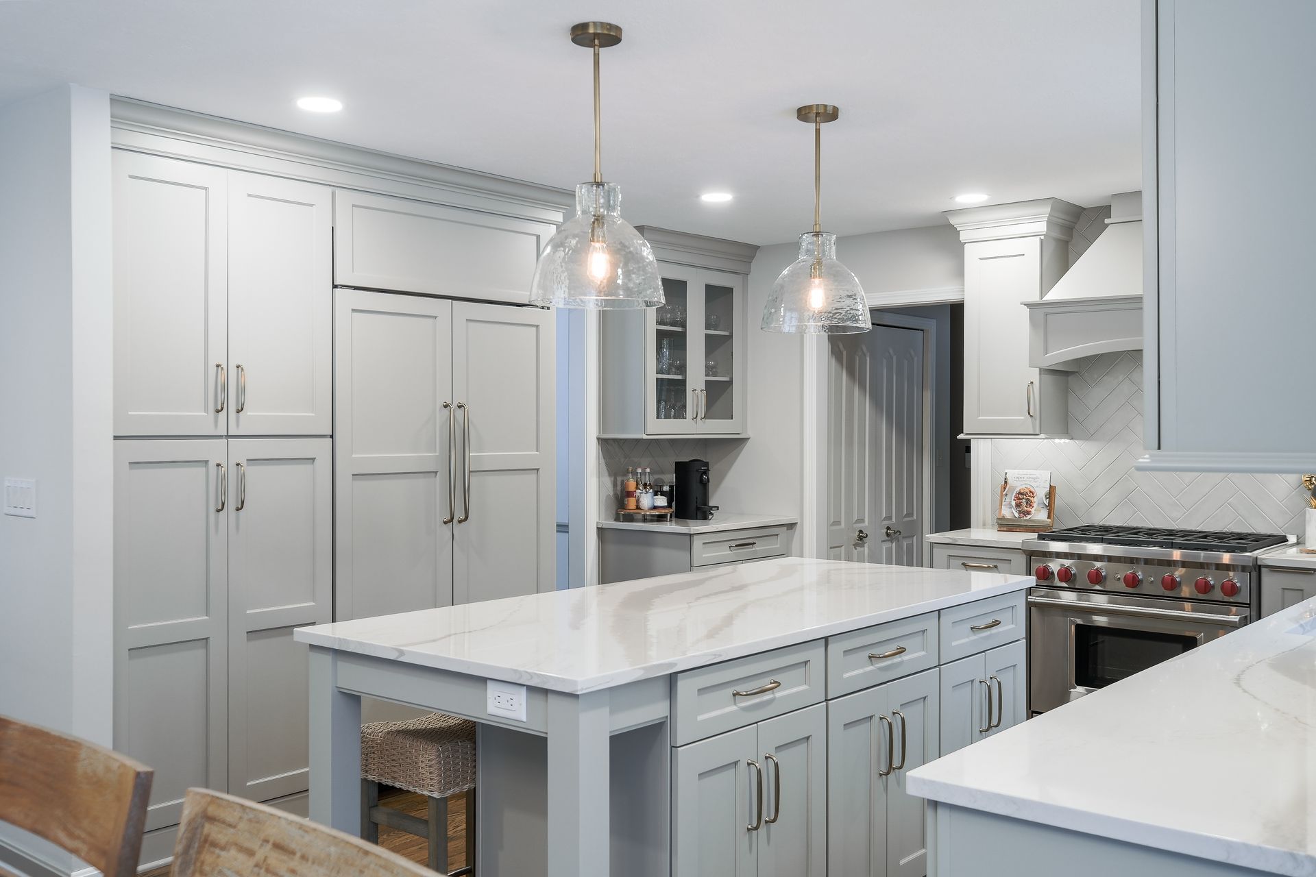 Gray kitchen with island and pendant lights. Cabinets, countertops, and appliances.