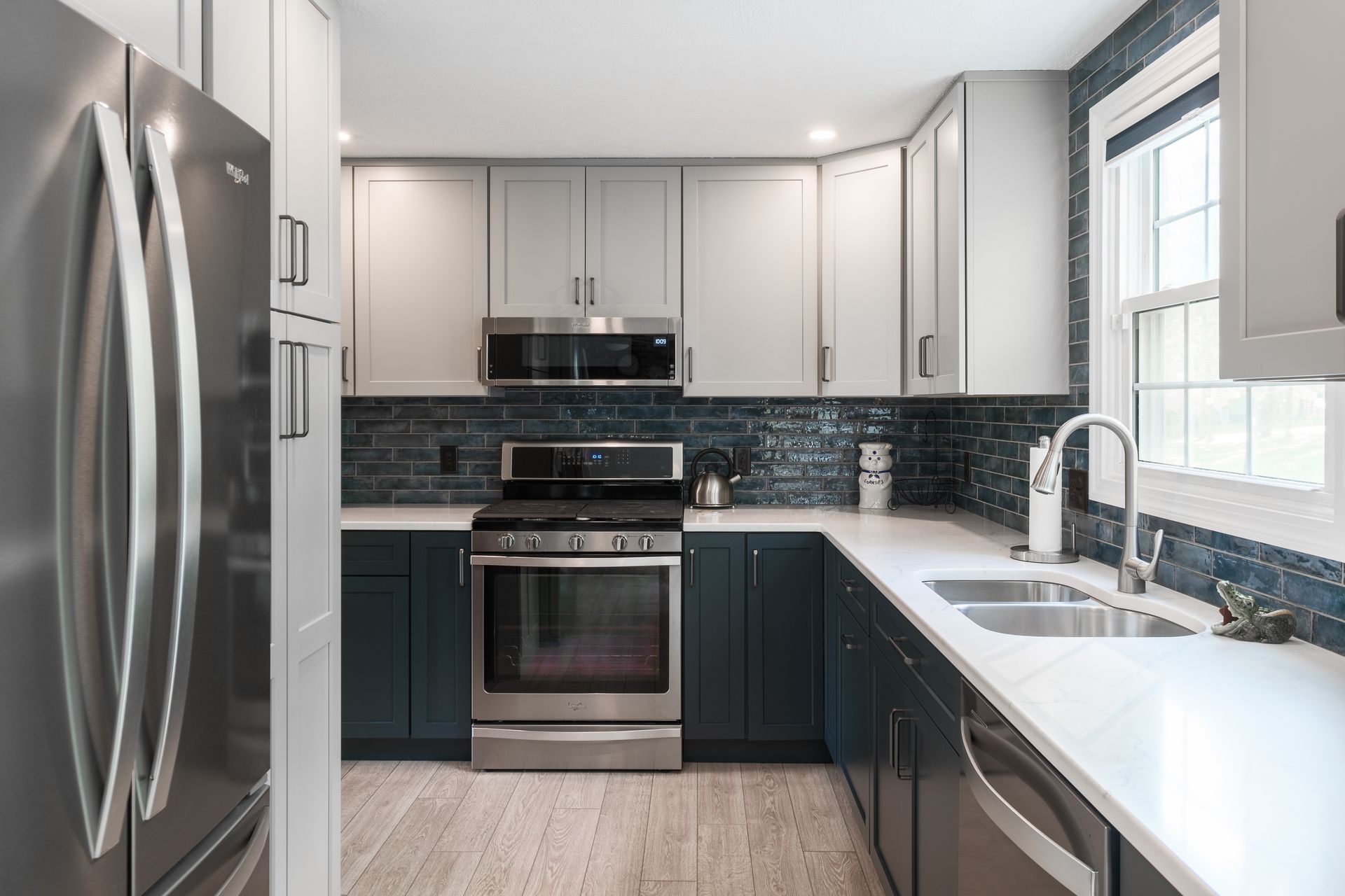A kitchen with stainless steel appliances and blue cabinets