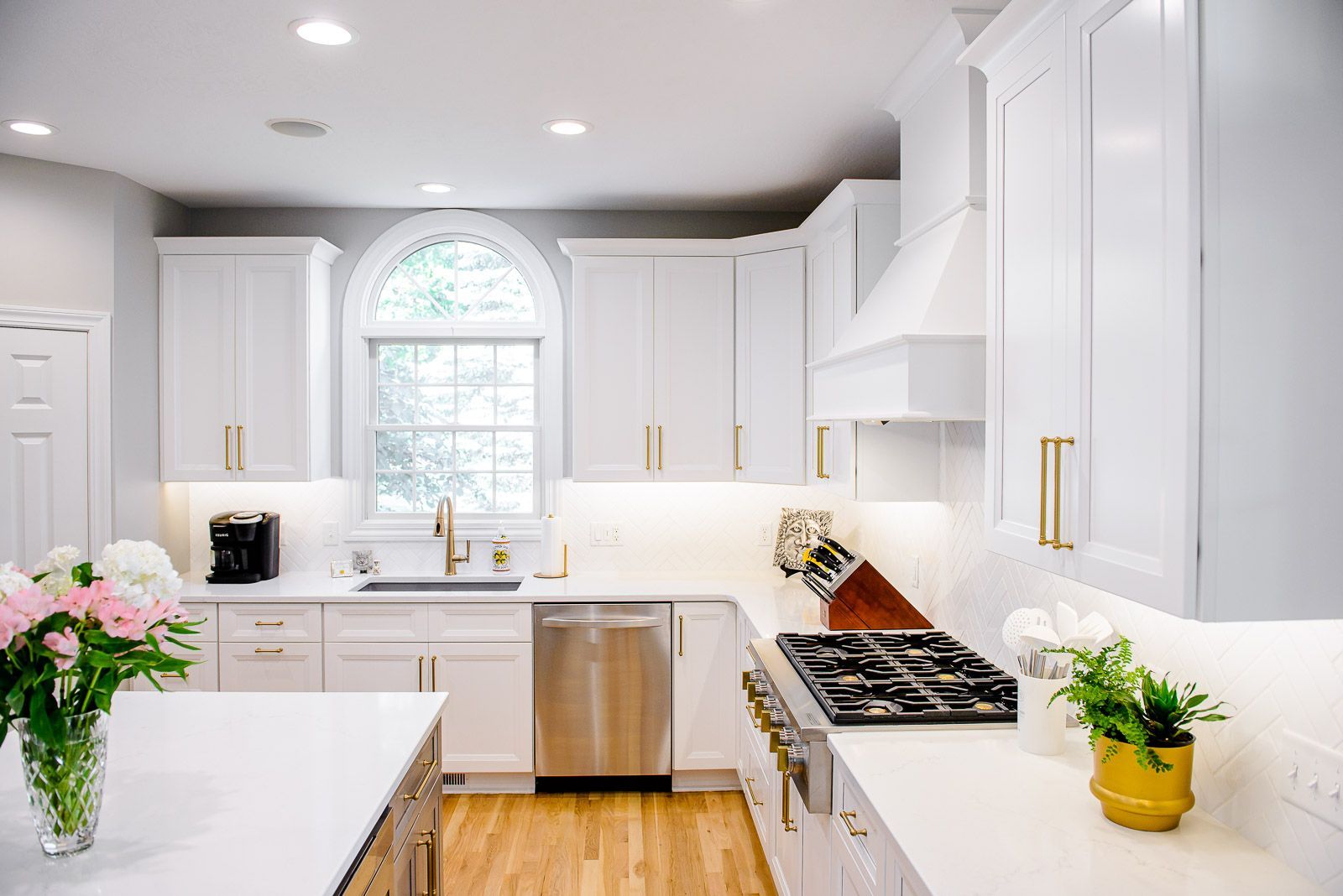 A kitchen with white cabinets and stainless steel appliances.
