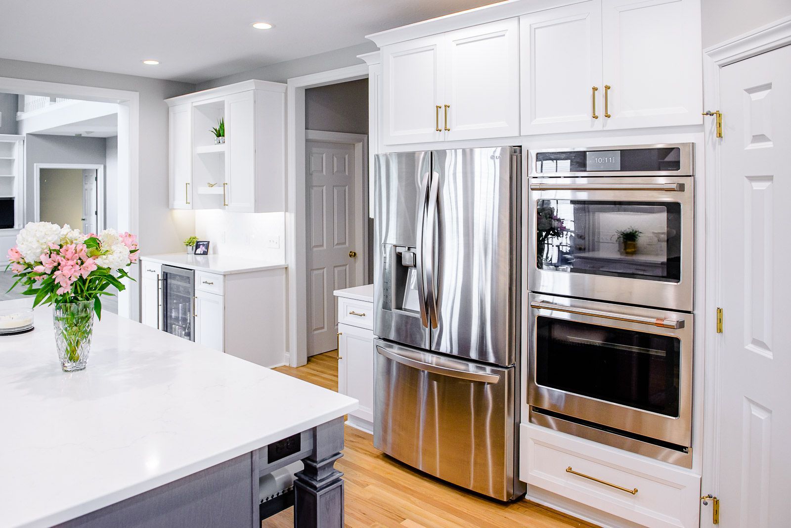 A kitchen with stainless steel appliances and white cabinets.