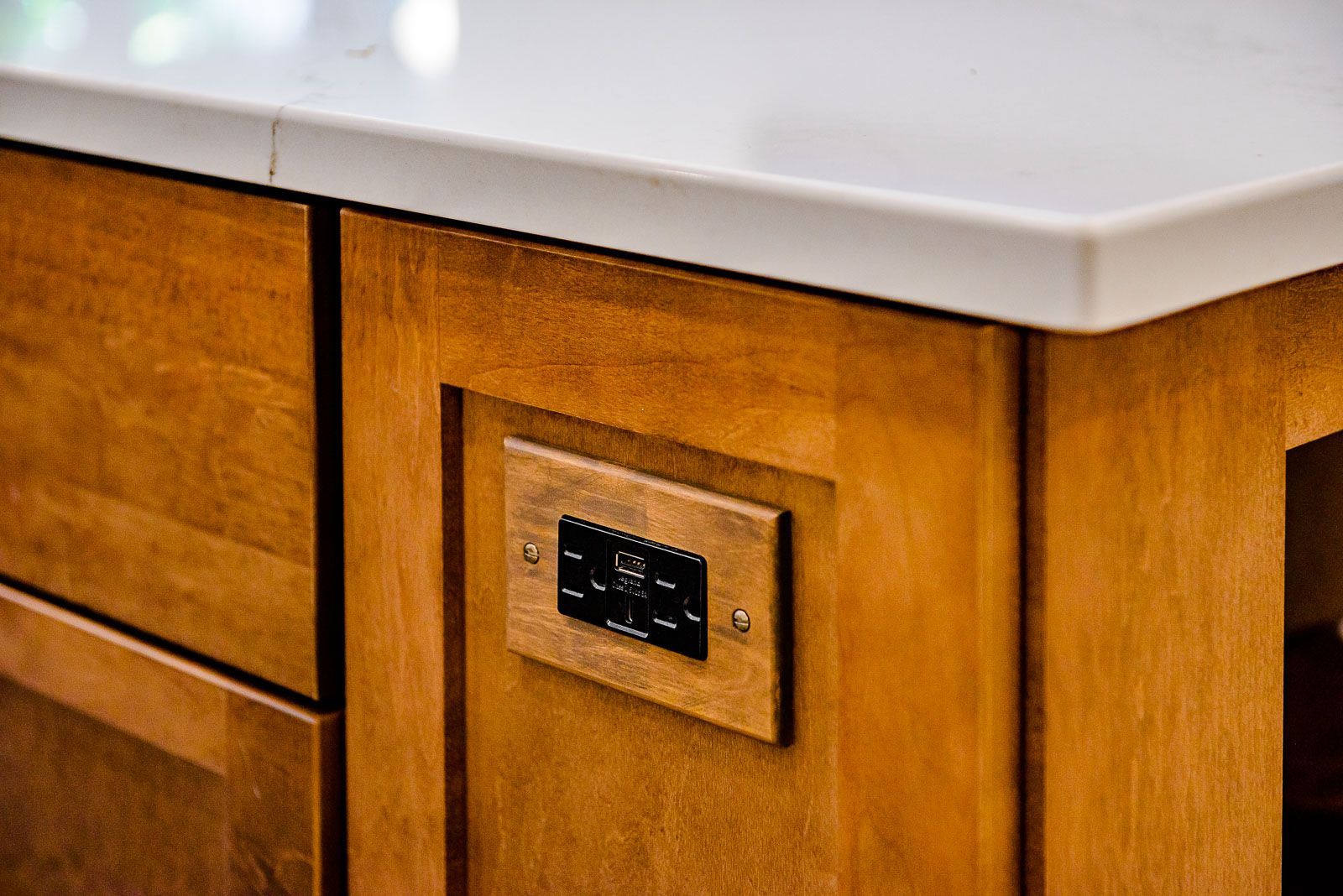 A wooden cabinet with a socket on the side of it.