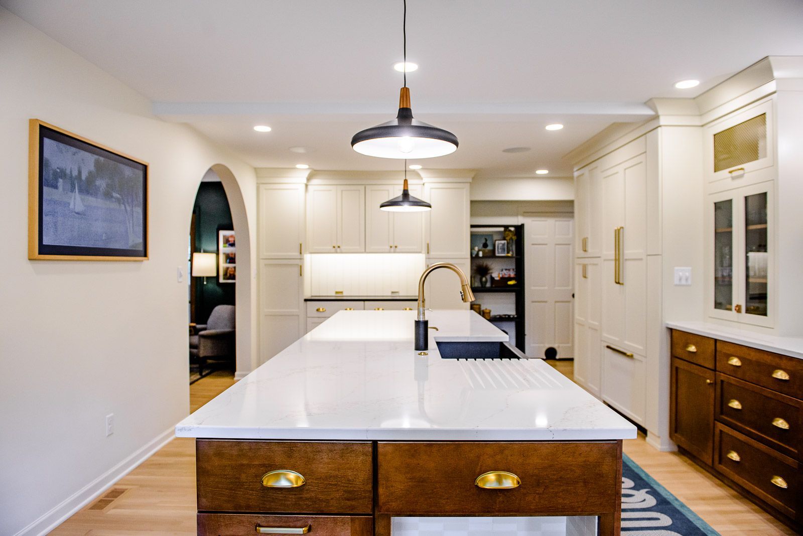 A kitchen with a large island and a sink.