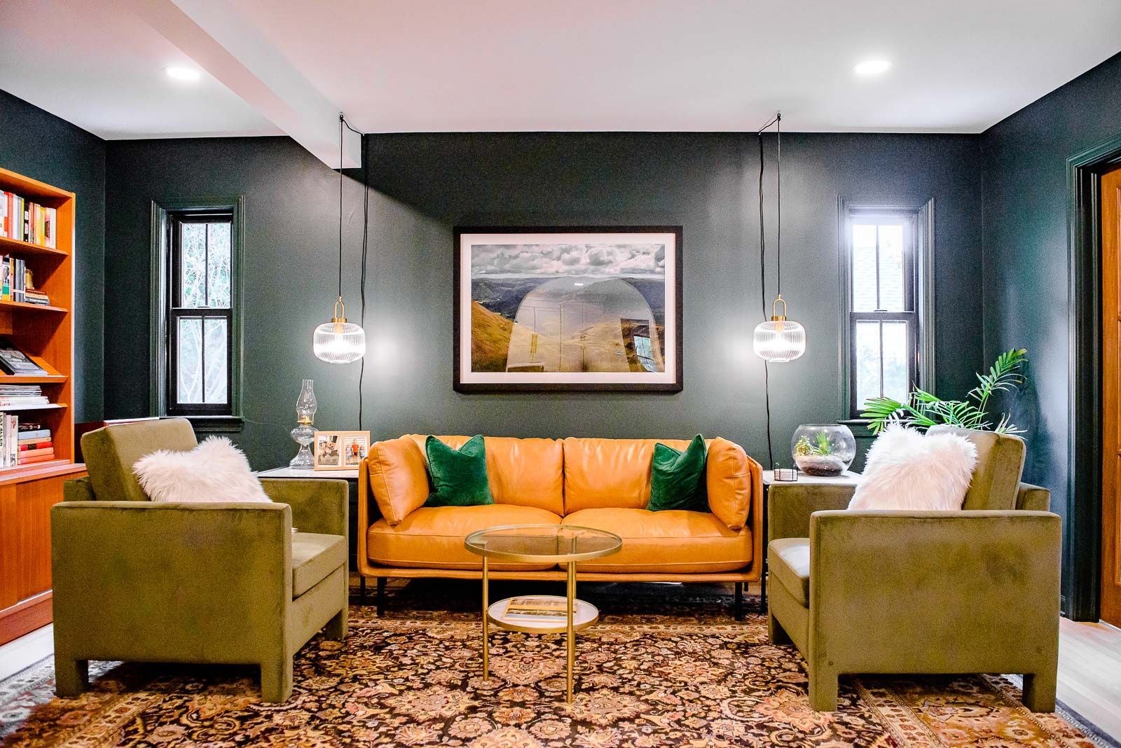 A living room with a couch , chairs , and a rug.