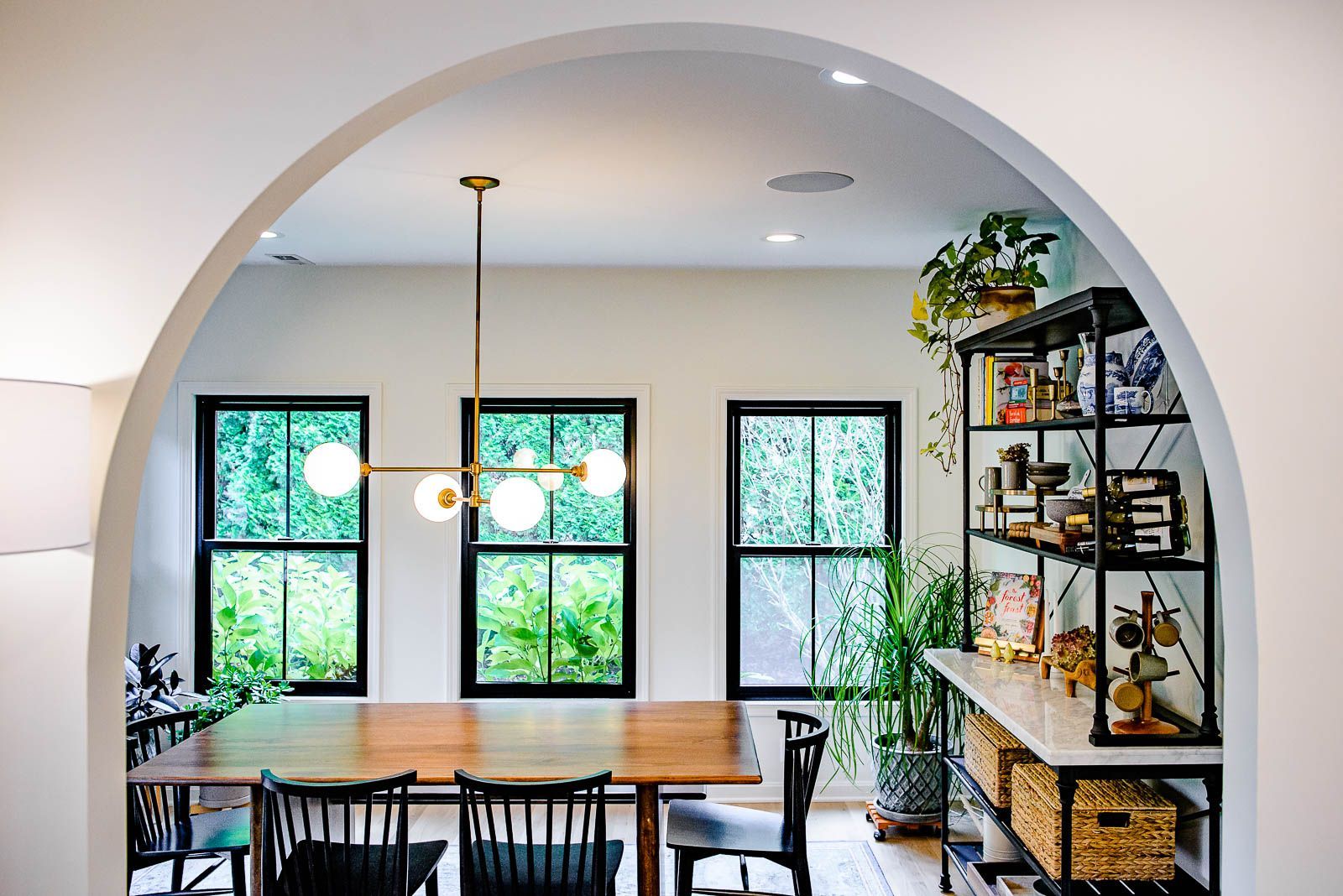A dining room with a table and chairs and a chandelier.