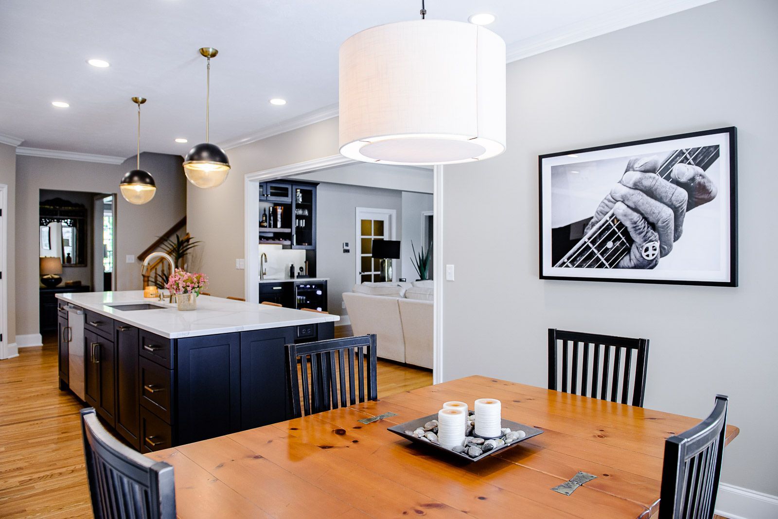 There is a picture of a person playing a guitar on the wall above the dining table.