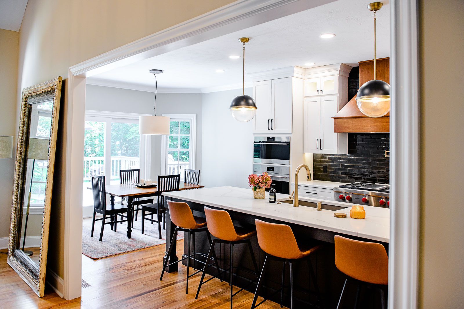 A kitchen with a large island and a dining room in the background.
