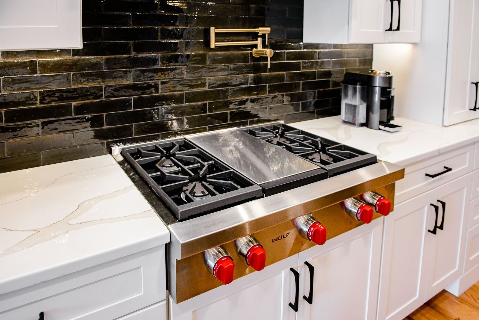 A stove top oven is sitting on top of a counter in a kitchen.