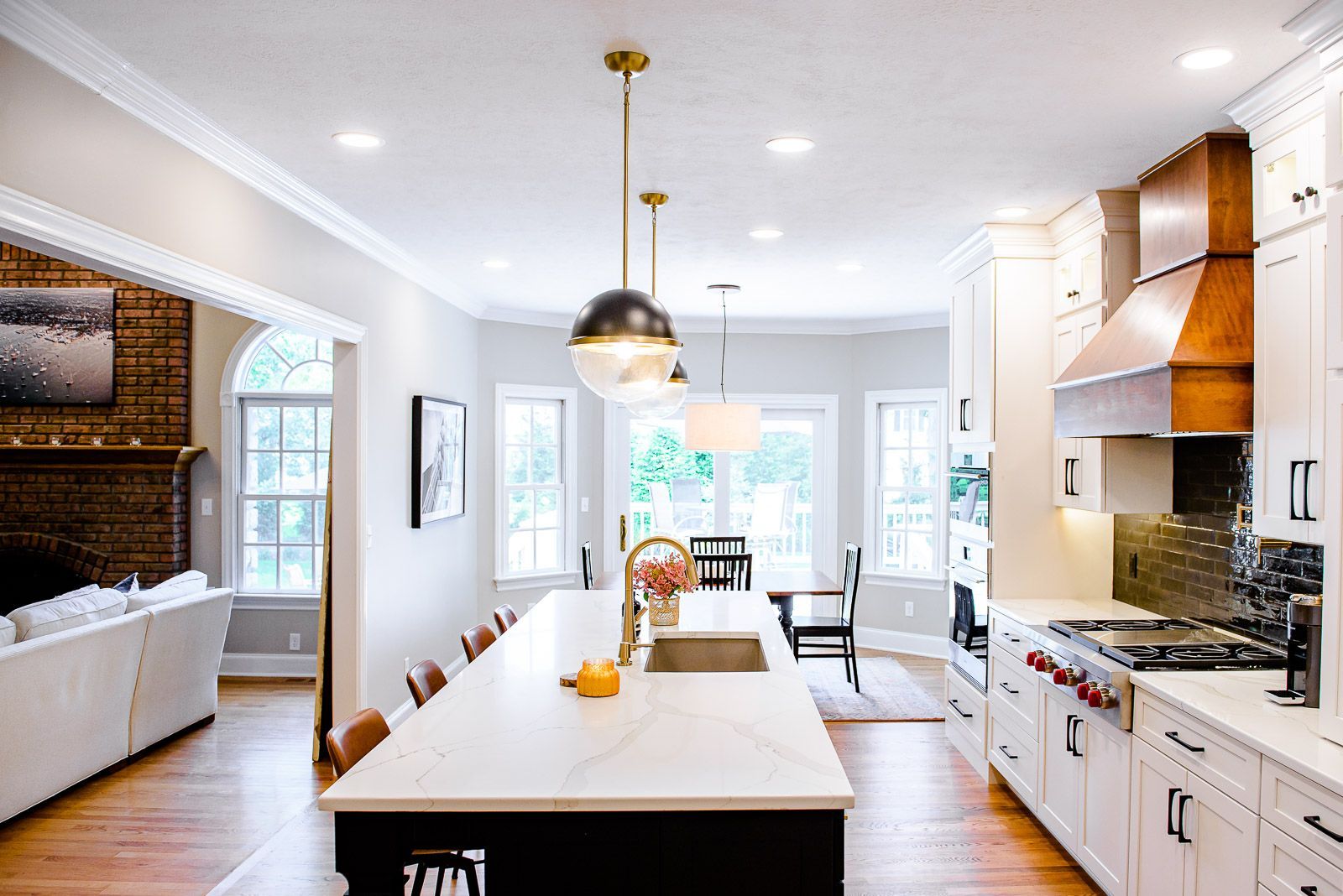 A kitchen with white cabinets and a large island in the middle.