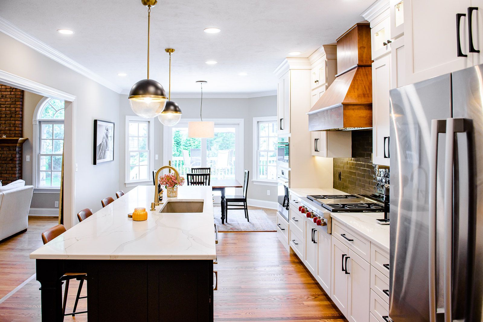 A kitchen with stainless steel appliances and a large island in the middle.