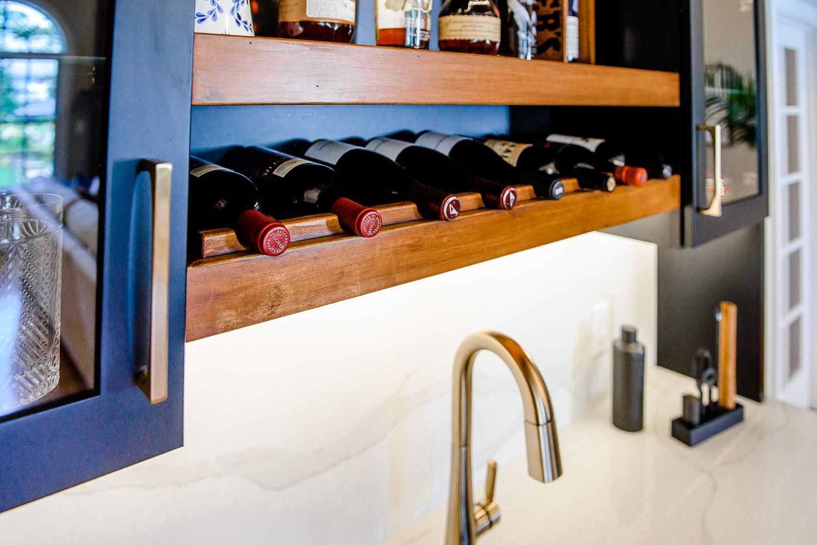A kitchen with a wine rack and a sink