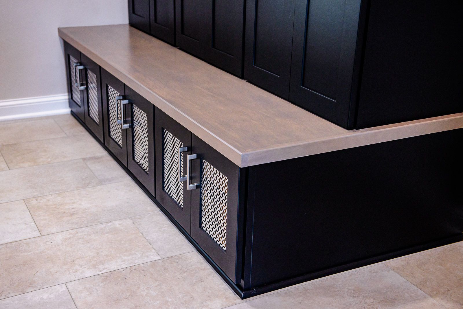 A row of black cabinets with a white counter top
