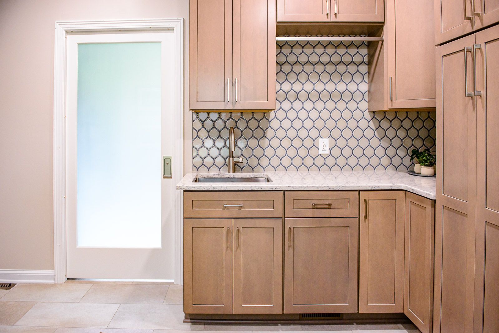 A kitchen with wooden cabinets and a sink.