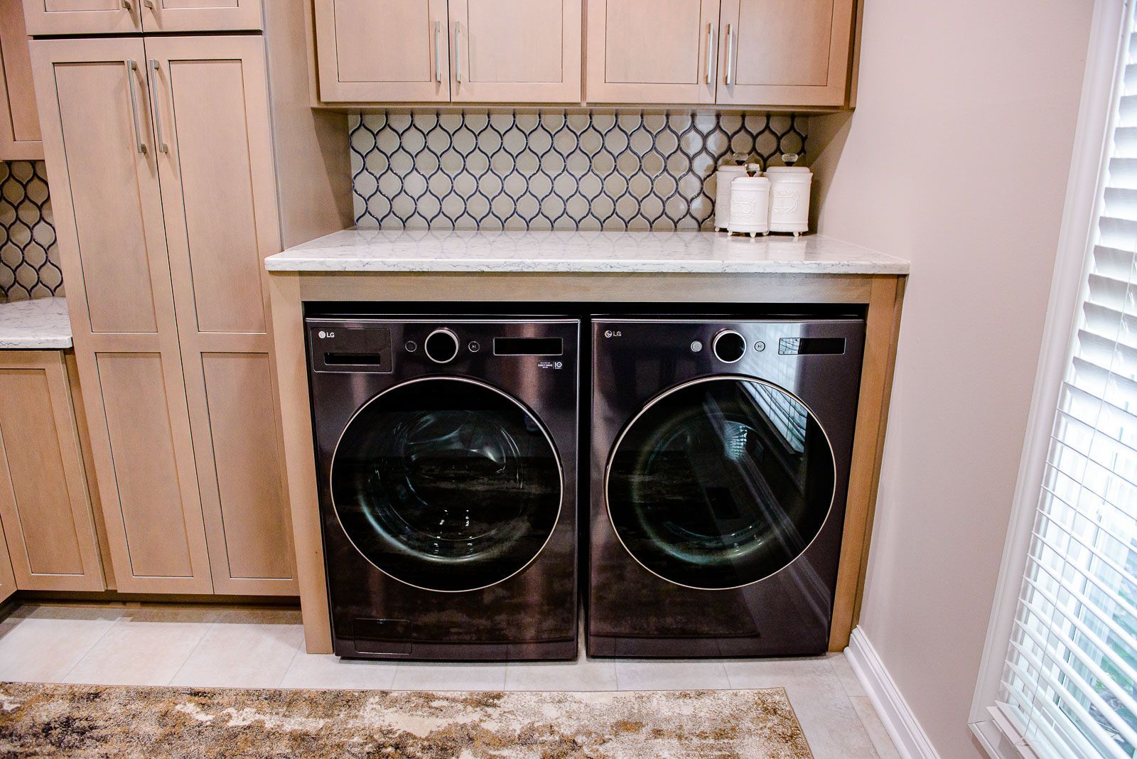 A laundry room with a washer and dryer in it.