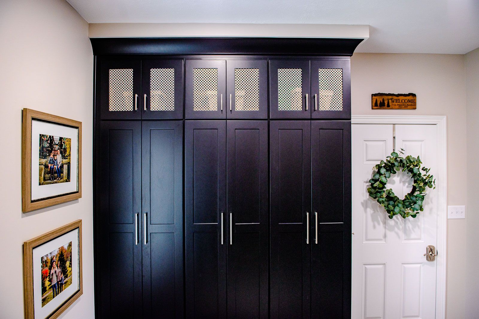 A room with a wreath on the door and a sign that says laundry