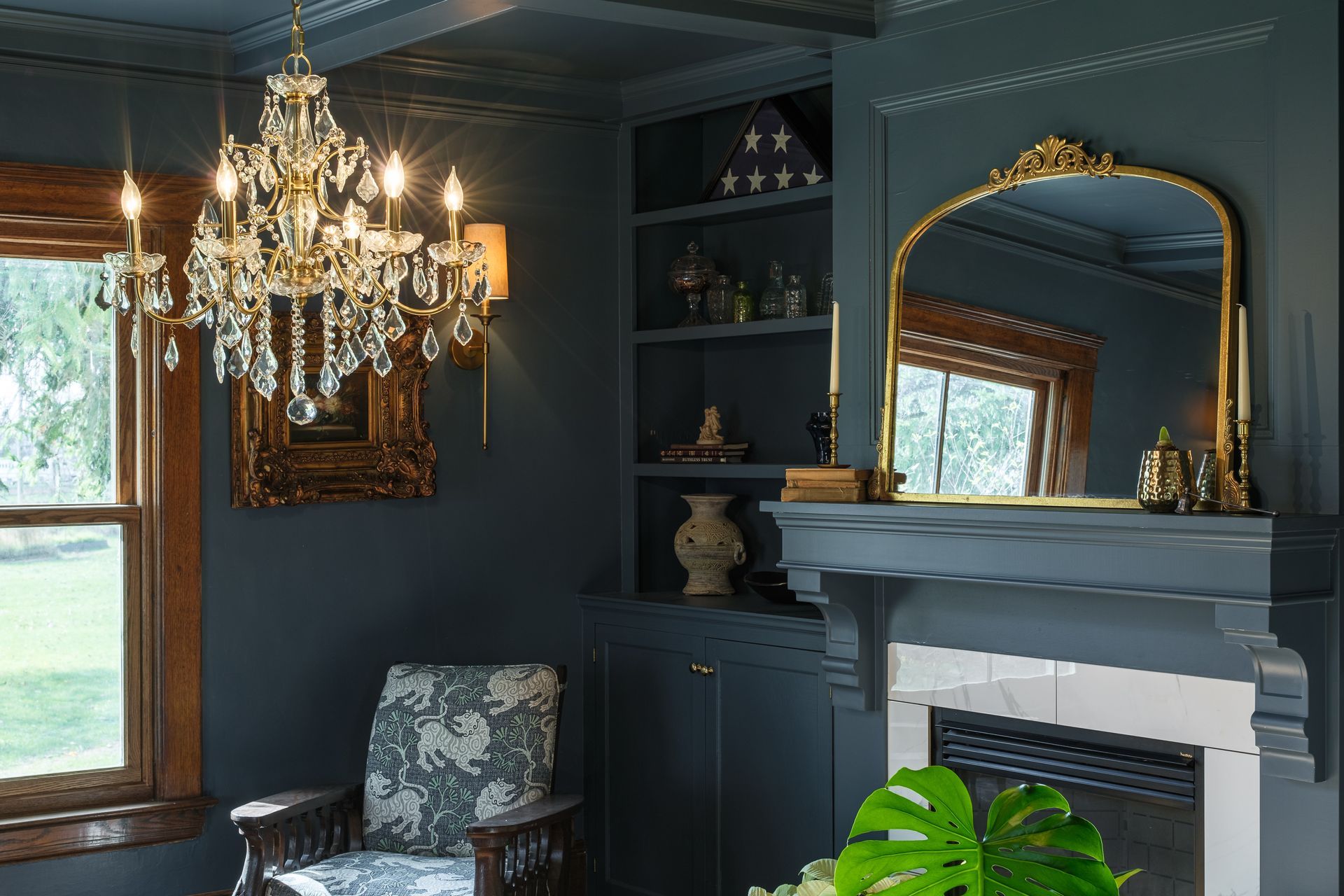 A living room with a fireplace and a chandelier