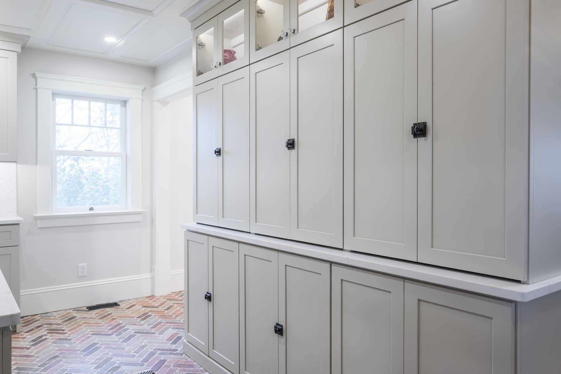 A kitchen with a lot of cabinets and a window.