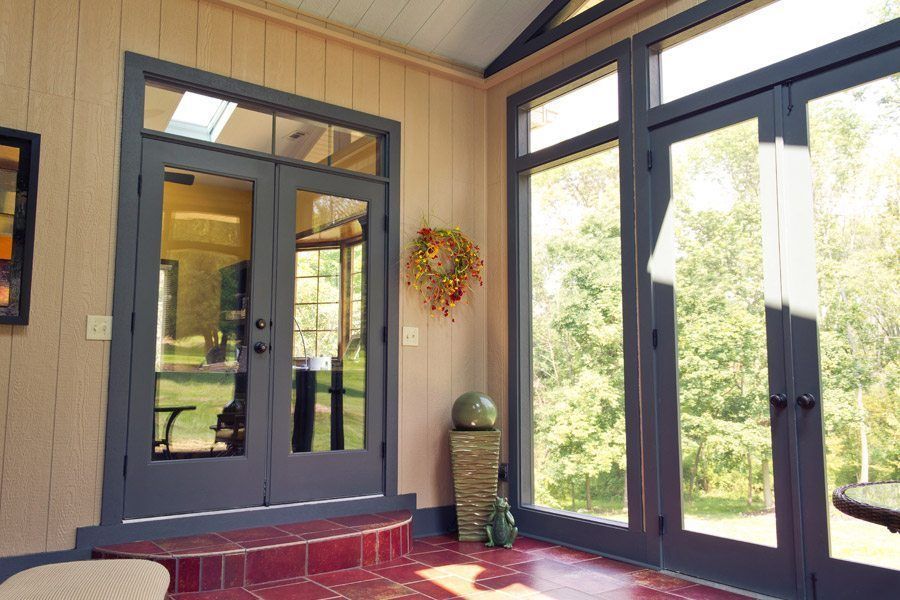 A sun room with a lot of windows and doors