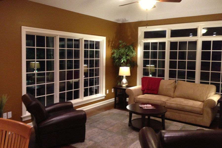 A living room with a couch and two chairs