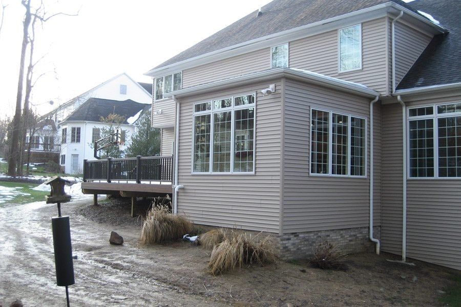 A house with a lot of windows and a deck