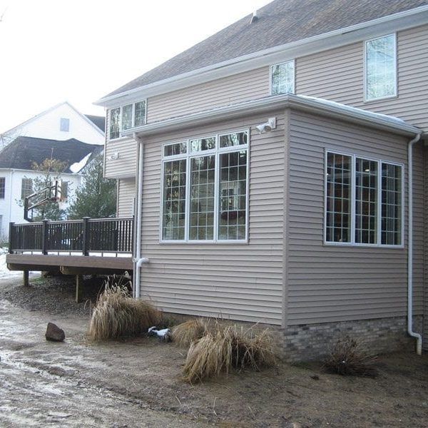 A house with a deck and a lot of windows