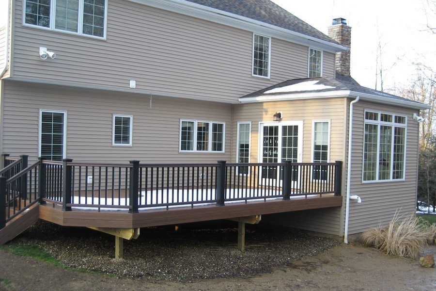 A large house with a large deck in front of it