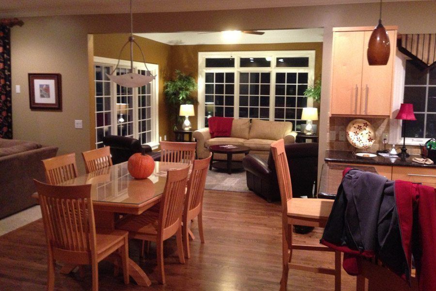 A living room with a table and chairs and a pumpkin on the table