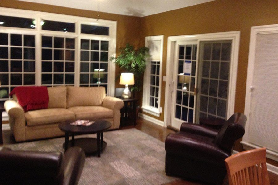 A living room with a couch and two chairs