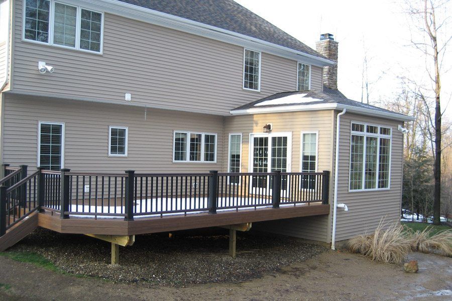 A large house with a large deck in front of it
