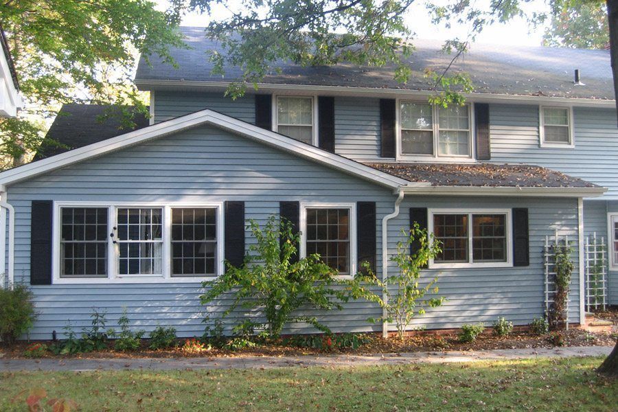 A blue house with black shutters and white trim