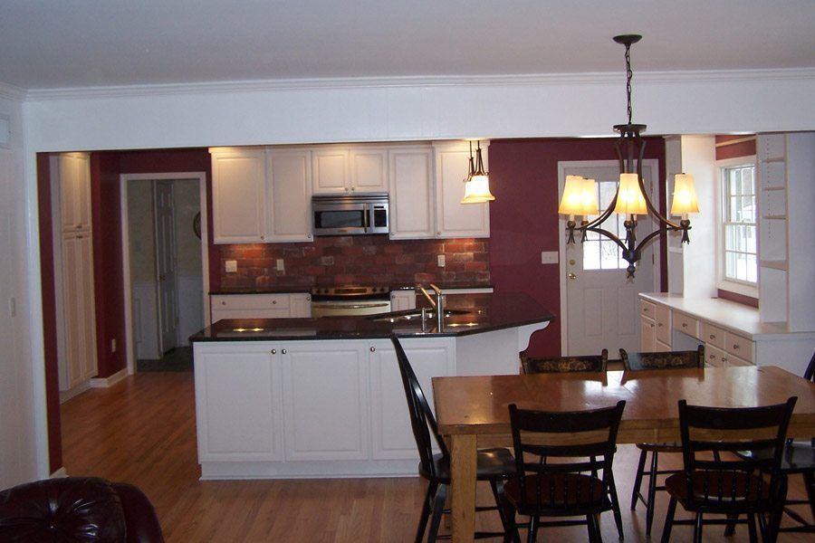 A kitchen with a table and chairs in it