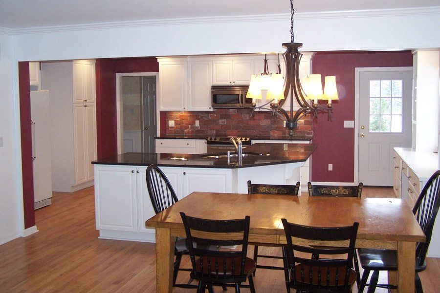 A kitchen with a table and chairs and a chandelier