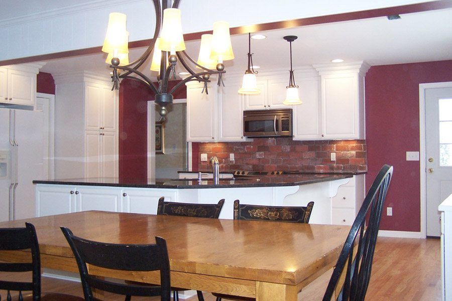 A kitchen with a table and chairs and a chandelier