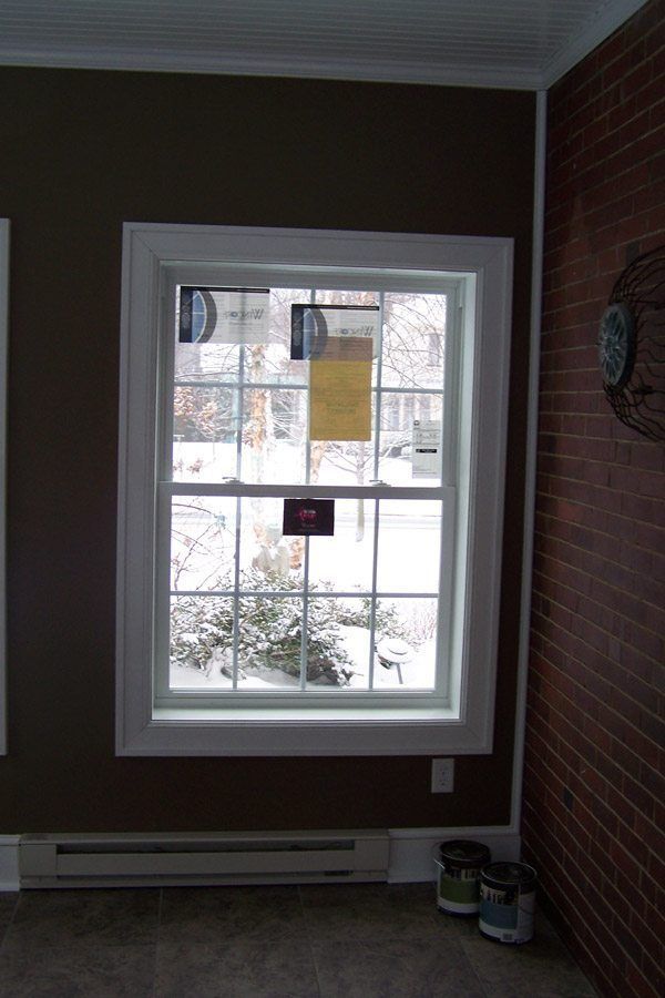 A room with a window and a clock on the wall.
