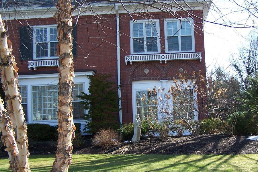 A large red brick house with a lot of windows