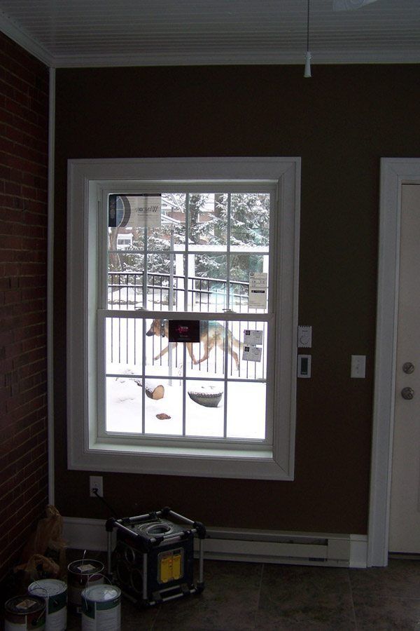 A room with brown walls and a large window