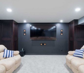 A living room with two couches and a flat screen tv