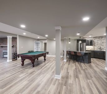 There is a pool table in the middle of the room.