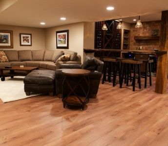 A living room with hardwood floors and a couch and chairs