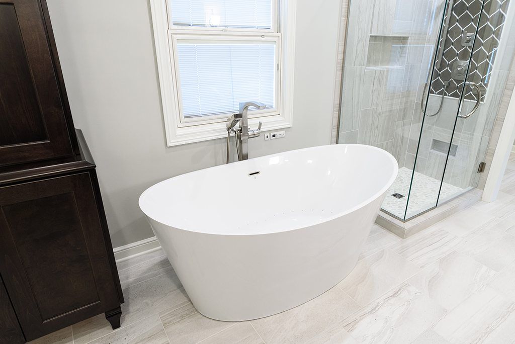 A bathroom with a bathtub and a walk in shower.