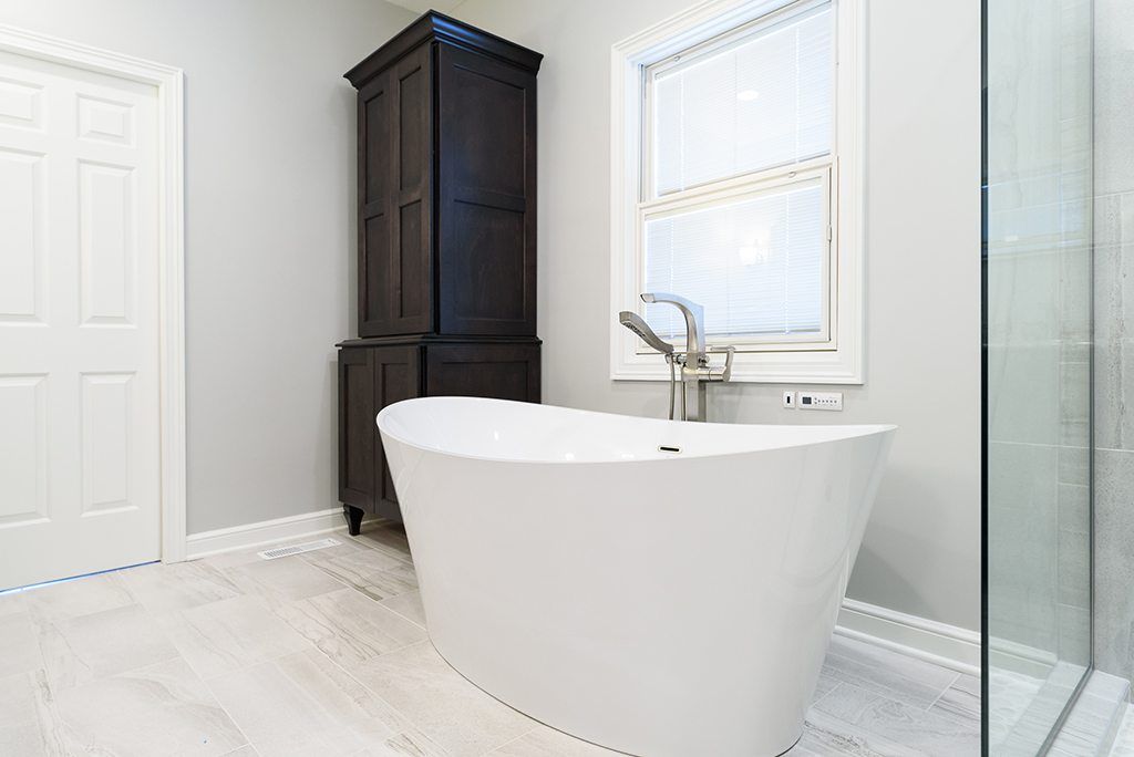 A bathroom with a tub and a walk in shower.