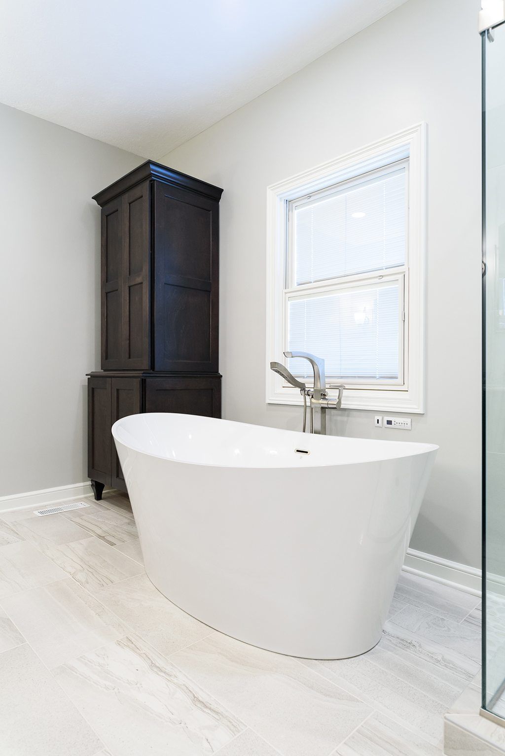A bathroom with a bathtub and a window.