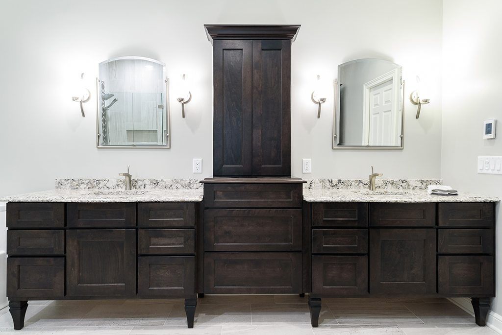 A bathroom with two sinks and two mirrors.