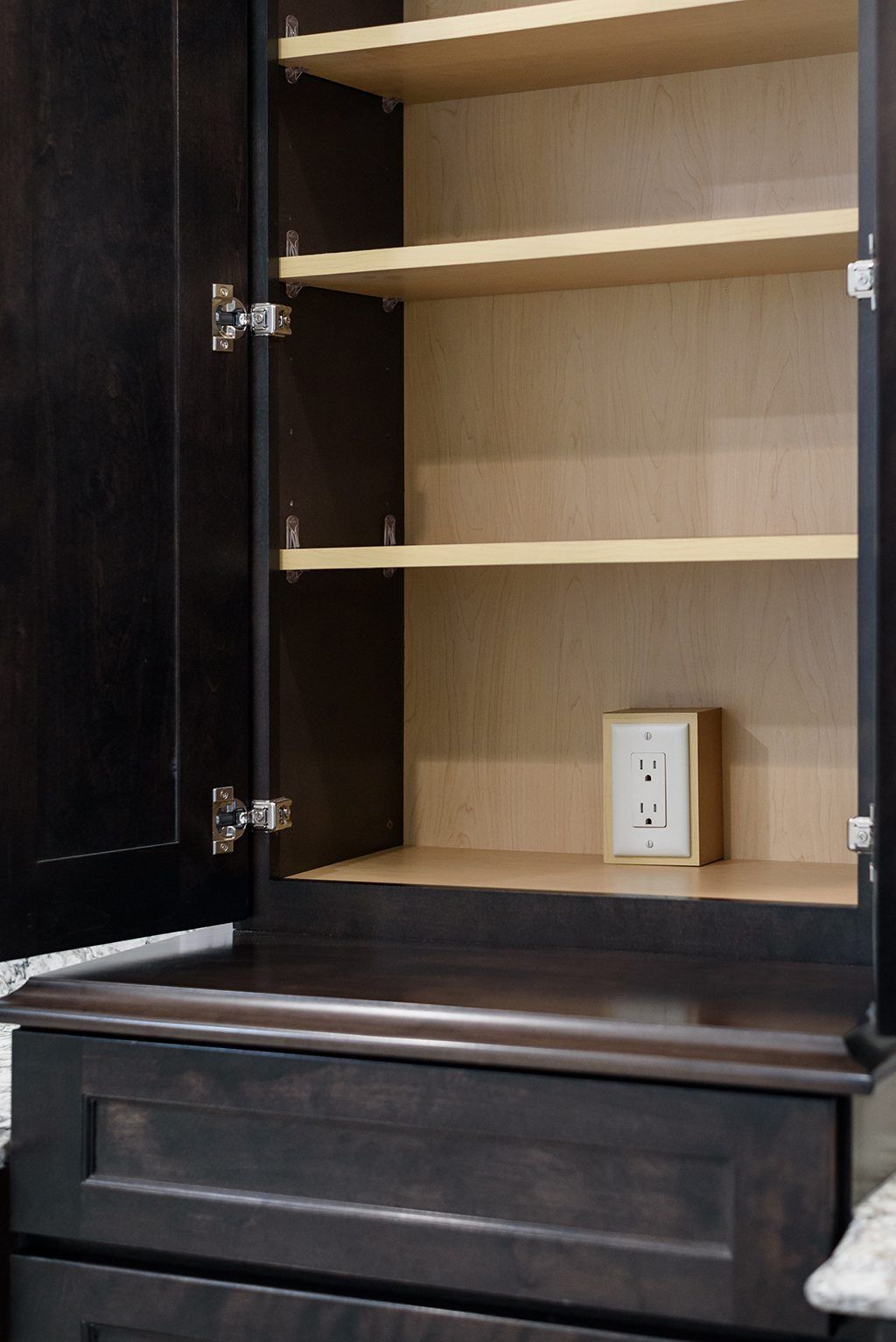 The inside of a cabinet with the doors open and shelves