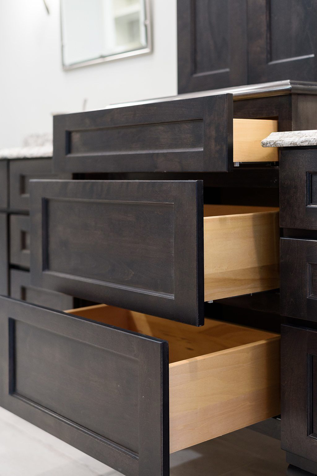 A close up of a bathroom vanity with drawers open.