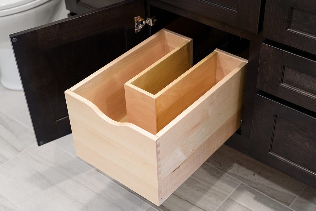 A bathroom vanity with a wooden drawer underneath it.