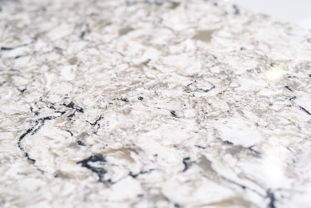 A close up of a white and black granite counter top.