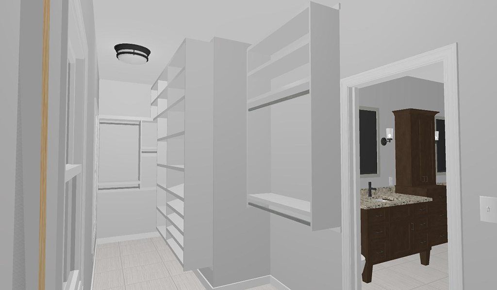 A walk in closet with lots of shelves and a bathroom in the background.