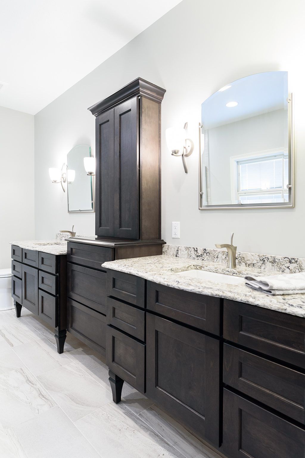A bathroom with two sinks and two mirrors.